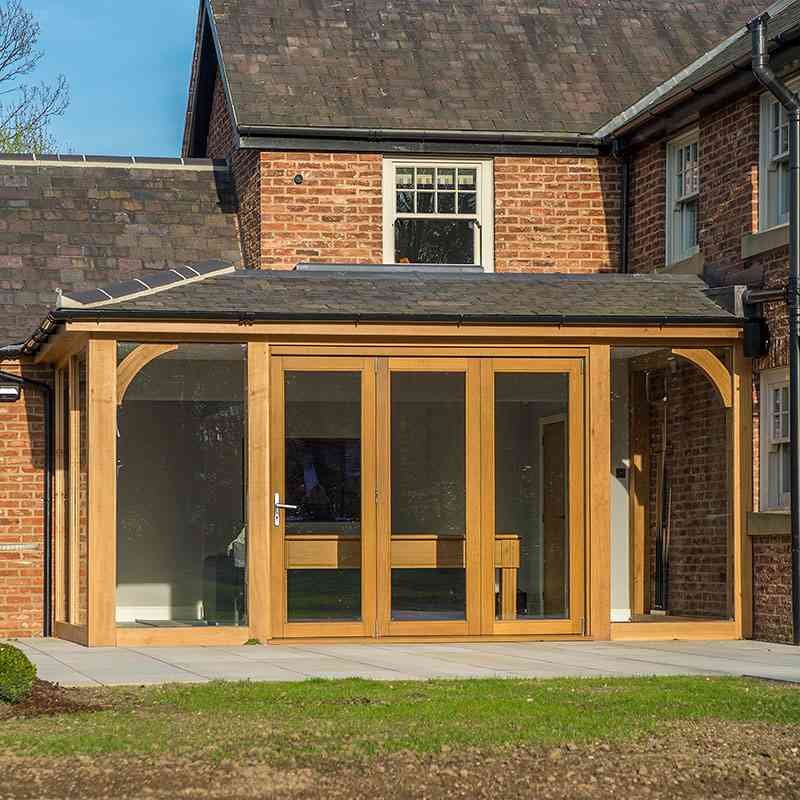 oak frame building conservatory with bi-fold doors